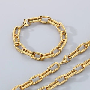 Detailed view of textured gold cuban link necklace and bracelet set with screw pattern