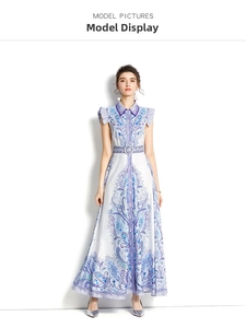 Detailed view of the blue paisley print on a white sleeveless collared A-line maxi dress
