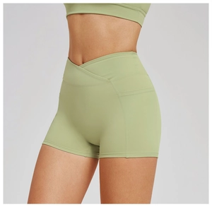 Detail of high-waist V-shaped crossover waistband and side pockets on yoga shorts