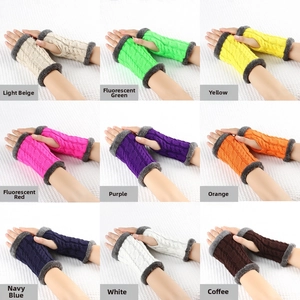 Detail view of cable knit fingerless gloves with faux fur trim in nine various colors