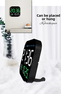 Detail of multi-functional LED digital clock showing date, temperature, and wall-mount stand