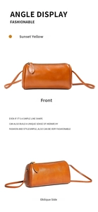 Detail view of the soft leather cylinder crossbody bag showing fine texture and smooth zipper.