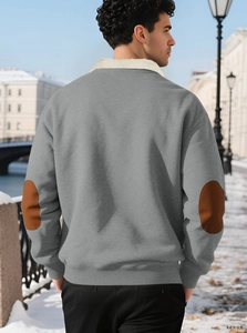 Detail of gray sweatshirt with brown elbow patches and white sherpa collar in snow