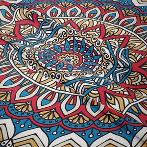Bohemian mandala tapestry with vibrant red and blue symmetric patterns for wall decor