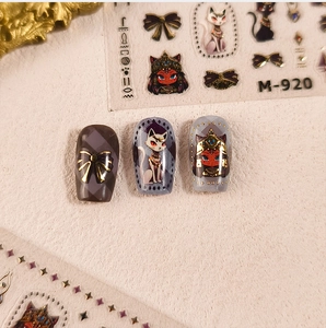 Detailed view of Egyptian cat goddess and pharaoh nail art stickers on manicured nails