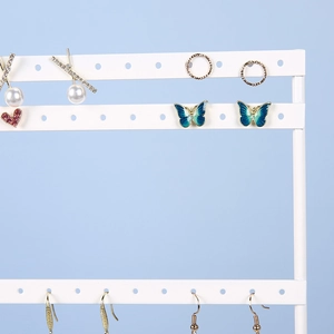 Three-tier white iron earring display stand with jewelry for home storage