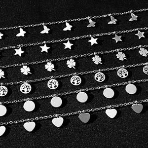 Detail of stainless steel Y-necklace featuring butterfly, star, and clover pendants