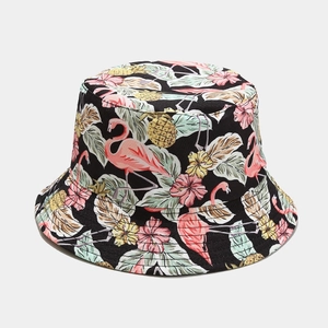 Close-up of tropical flamingo and pineapple print on black canvas sun hat fabric
