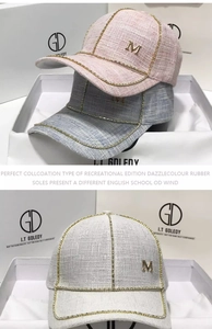 Detail of tweed baseball caps in pink and blue featuring rhinestone trim and metal M logo