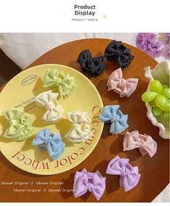 Flat lay of satin bow hair claws in macaron colors on a rustic wooden table setup