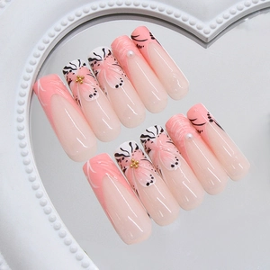 Long trapezoid press-on nails with 3D floral patterns, pearls and pink French tips