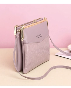Side view of pink crocodile pattern shoulder bag with multi-layer design and metal frame