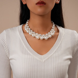 Detail of multi-row pearl choker necklace with rhinestones worn by a model
