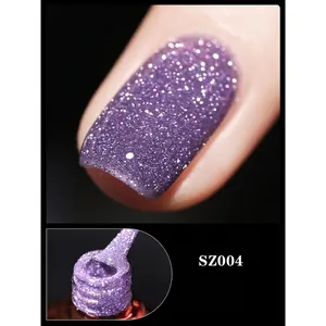 Macro shot of purple diamond glitter nail polish with brush and sparkling finish effect