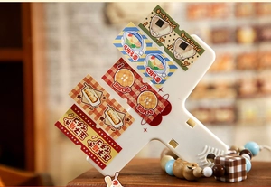 Macro detail of white metal binder clips with cute Japanese food 3D miniature charms