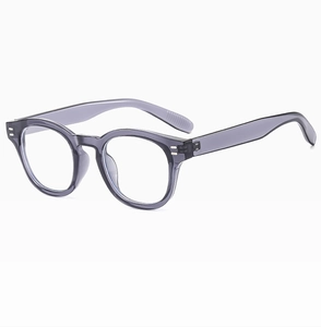 Detail shot of vintage round transparent grey frames with silver rivet accents