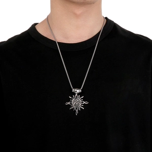 Silver sun pendant necklace with Celtic knot worn by a model on a black t-shirt