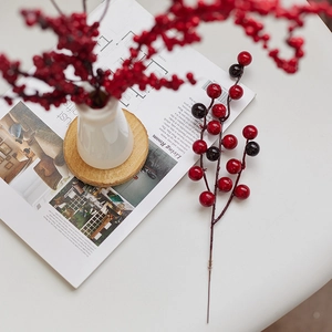 Artificial red berries branch for Christmas tree decor in a minimalist lifestyle setting