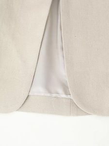 Detailed back slit view of beige sleeveless top with premium woven texture and satin lining