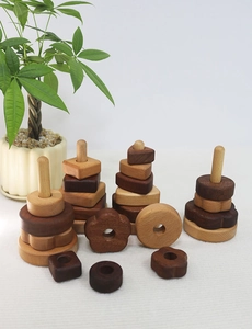 Detail of wooden stacking blocks in geometric shapes with natural wood grain and textures