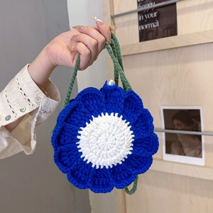 Handmade blue flower crochet shoulder bag with white center and green straps