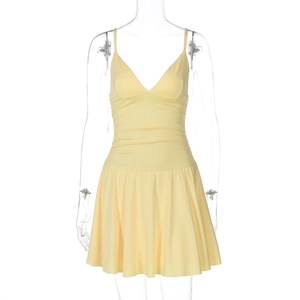 Detailed view of yellow V-neck dress featuring pleated waist and ruffled hemline