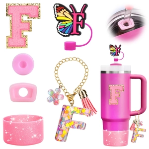 Pink accessory set with letter F charm, butterfly straw topper, and glitter boot for Stanley cup