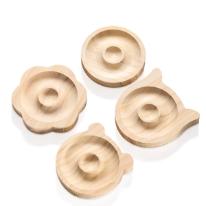 Detail of wooden jewelry design tray with circular grooves and smooth natural grain