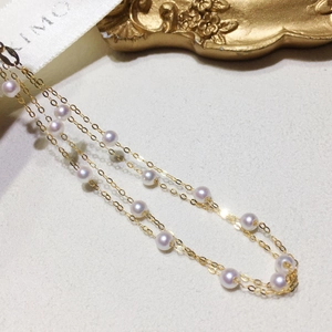 Elegant 18k gold layered bracelet featuring natural freshwater pearls and minimalist chain