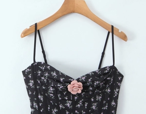 Detail of floral corset top featuring a 3D pink flower and delicate purple flower pattern