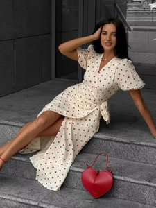 Detail of cotton heart print wrap dress with puff sleeves and waist tie fastening