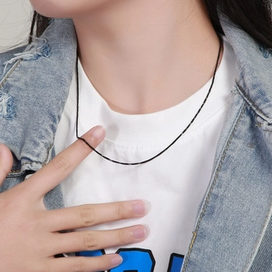 Minimalist black stainless steel snake chain necklace for women shown on a model