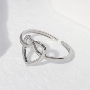 Minimalist silver heart infinity open ring made of stainless steel on white background