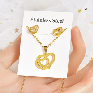 Detail of gold-plated stainless steel jewelry set with double heart pendants on card