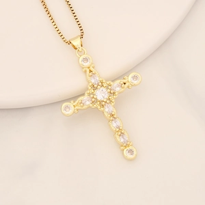 Close-up of 18K gold-plated cross pendant with sparkling clear cubic zirconia stones
