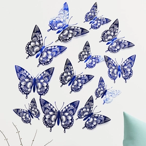Artistic layout of blue and white hollow-out paper butterflies on a minimalist wall