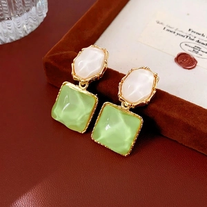Elegant gold-framed earrings with white and green faux gemstones in a retro design