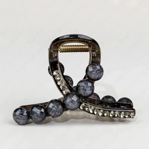 Detail of vintage hair claw with grey stone beads and sparkling crystal rhinestones
