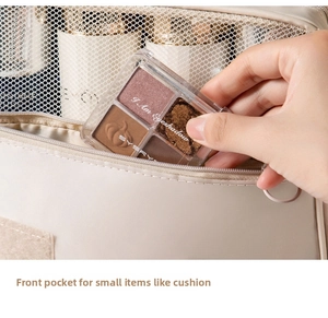 Detail of hanging toiletry bag showing the front pocket storing small makeup items