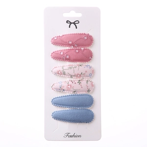 Detail of 6-piece embroidered floral fabric hair clips set on white display card