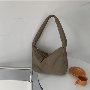 Detail view of the khaki puffer tote bag with a cloud-like design and zipper closure