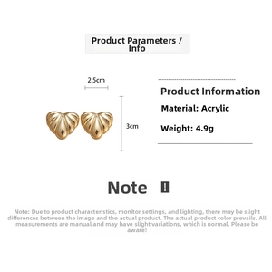 Detailed view of gold acrylic heart earrings showing 3cm height and 2.5cm width dimensions