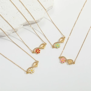 Detailed view of golden heart and flower pendants on minimalist necklaces