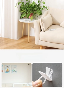 Adhesive wall fixture clip for climbing plants with a white ring hook design in living room