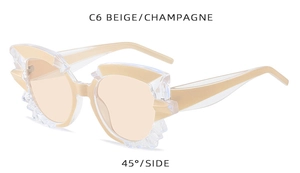 Detailed 45-degree view of beige and champagne irregular jagged sunglasses frames