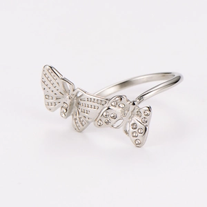 Macro shot of silver butterfly ring with sparkling rhinestones and hollow wing detail