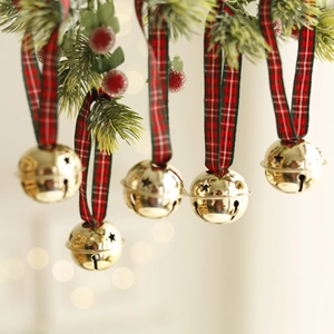 Set of 6 gold Christmas bells with star cutouts and festive plaid ribbons on a tree