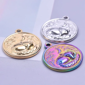 Macro view of fox and moon relief pendants in gold, silver, and rainbow steel