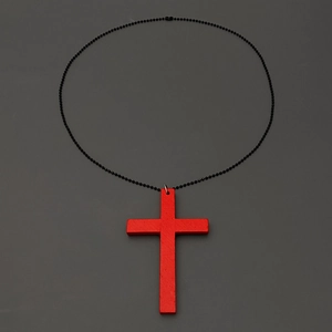 Detailed view of red wooden cross pendant with black ball chain on dark background