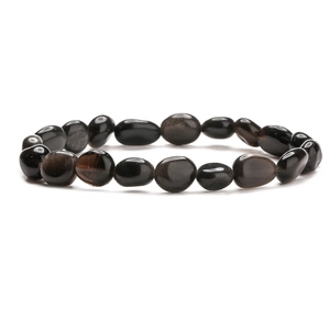 Macro detail of irregular obsidian stone beads on a polished minimalist gemstone bracelet